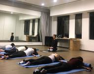 The instructor guiding the participants to do different yoga poses during the Yin Yang Yoga for Beginners